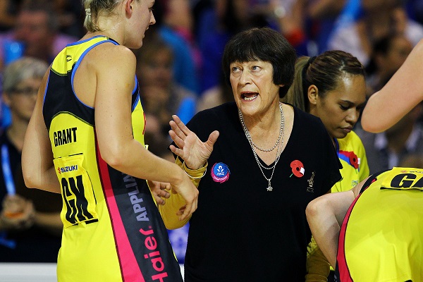 Netball coach on court with the team