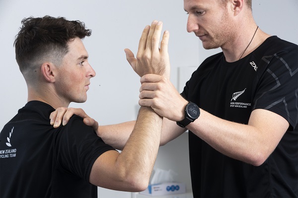 A physio checks an athletes arm movement